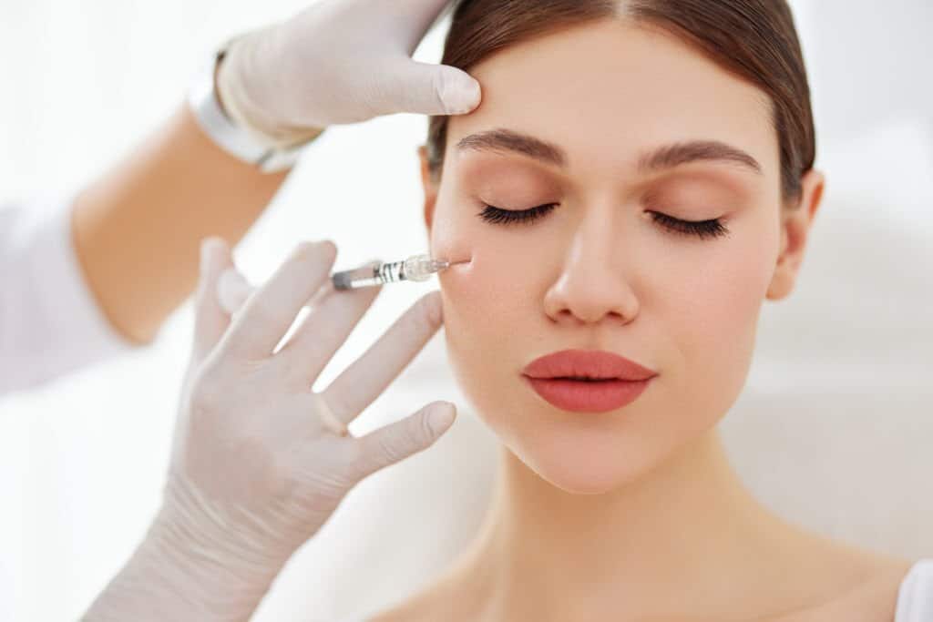 Female patient getting botox from professional cosmetologist