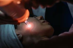 Beautician doing laser facial treatment for female customer
