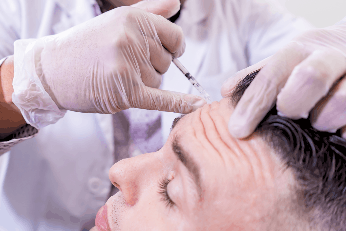 Botox injection in a man's forehead